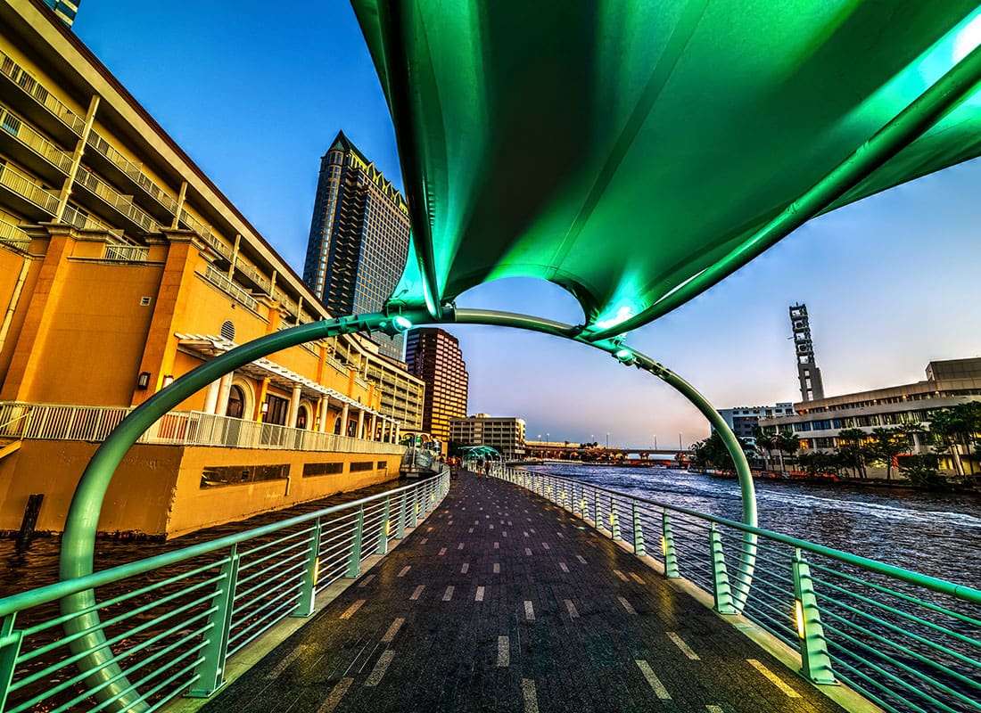 About Our Agency - Green Light Up Walkway by the Water in Downtown Tampa Florida in the Evening